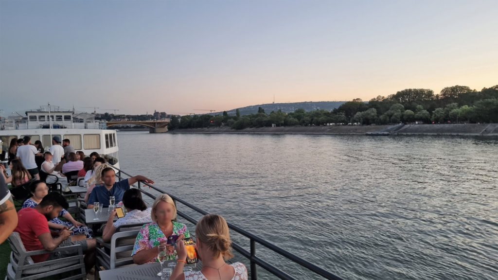 Dusk photo from the deck of a cruise ship moving along the Danube River, Budapest