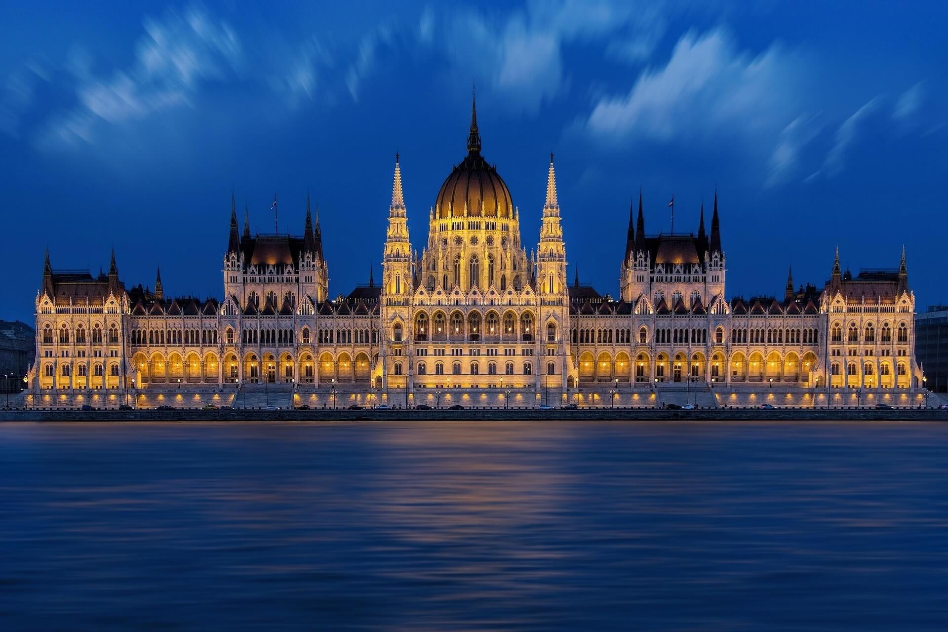 the illuminated parliament in Budapest at dusk