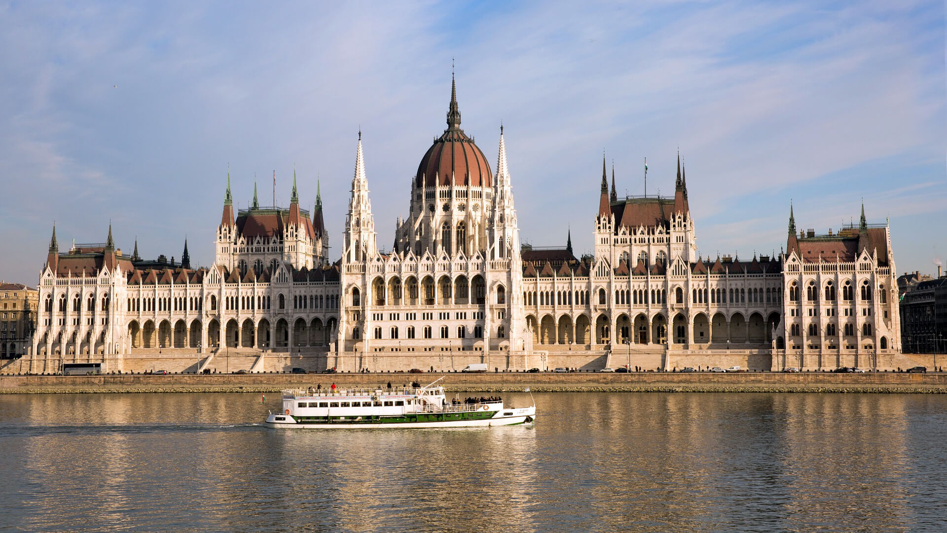 A boat sailing on the Danube River passes in front of the Hungarian Parliament during a sightseeing cruise