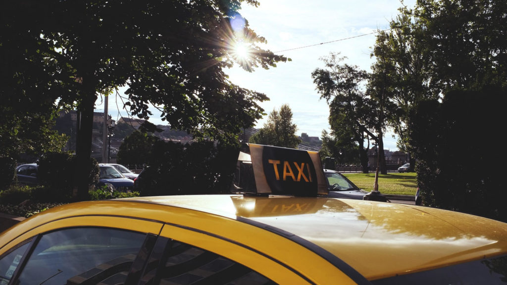 yellow taxi sign on car in budapest