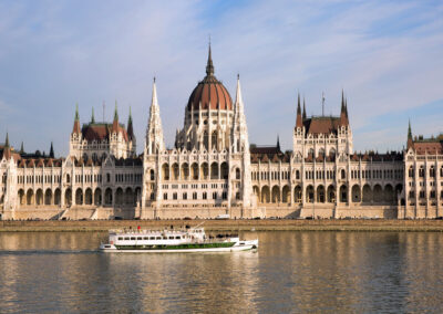A boat sailing on the Danube River passes in front of the Hungarian Parliament during a sightseeing cruise